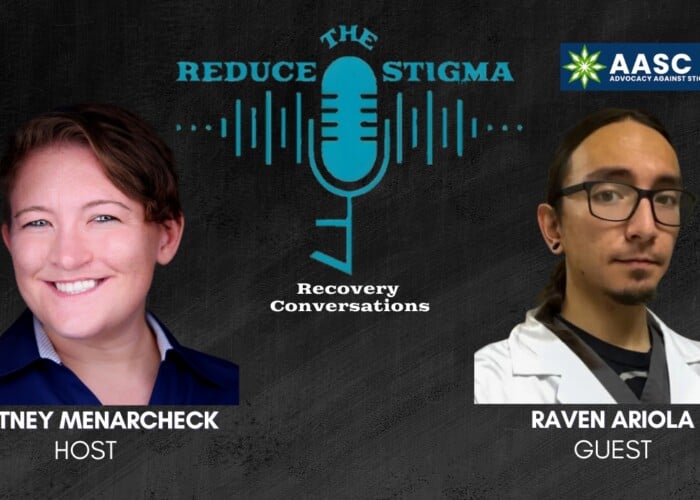 Reduce the Stigma cover image with Raven Ariola, co-creator of the Advocacy Against Stigma Conference. Raven is a man who has glasses and dark hair pulled back into a ponytail. He is wearing a black shirt and what appears to be a white lab coat.