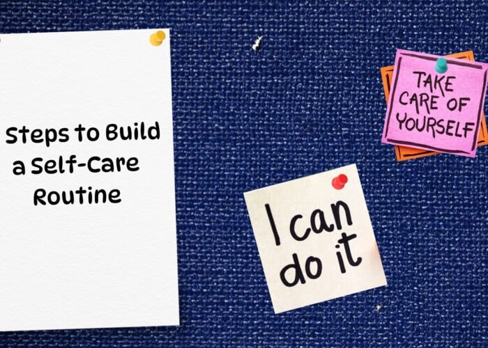 Blue Denim pushpin board. On left is a white piece of paper that says 5 steps to build a self-care routine. In the bottom middle is a yellow post it that says I can do it. In the upper right is a pink post-it on top an orange post-it that's slightly skewed so you can see the orange below. The pink post-it says take care of yourself.