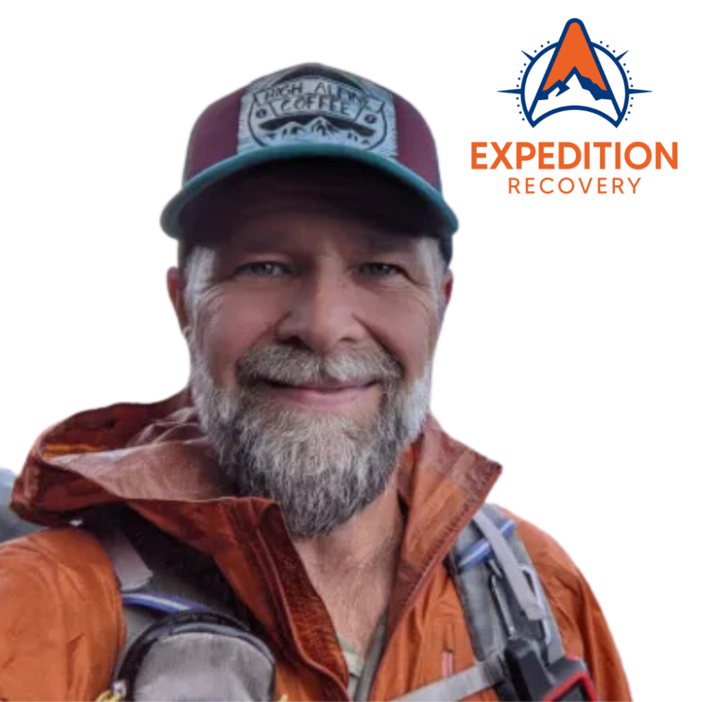 Portrait of Ken Dunn, Owner of Expedition Recovery, smiling and wearing a hat and an outdoor jacket with a backpack. The Expedition Recovery logo is displayed in the top right corner of the image.