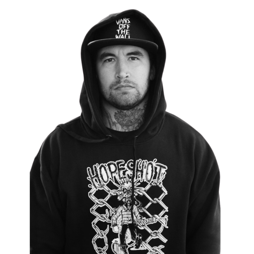 A cutout image of Nathan Smiddy, also known as "Narcan Nate," wearing a black hoodie with the "Hope Shot" design on the front and a black cap with the phrase "Vans Off The Wall." He has a neutral expression, visible tattoos, and a calm demeanor.