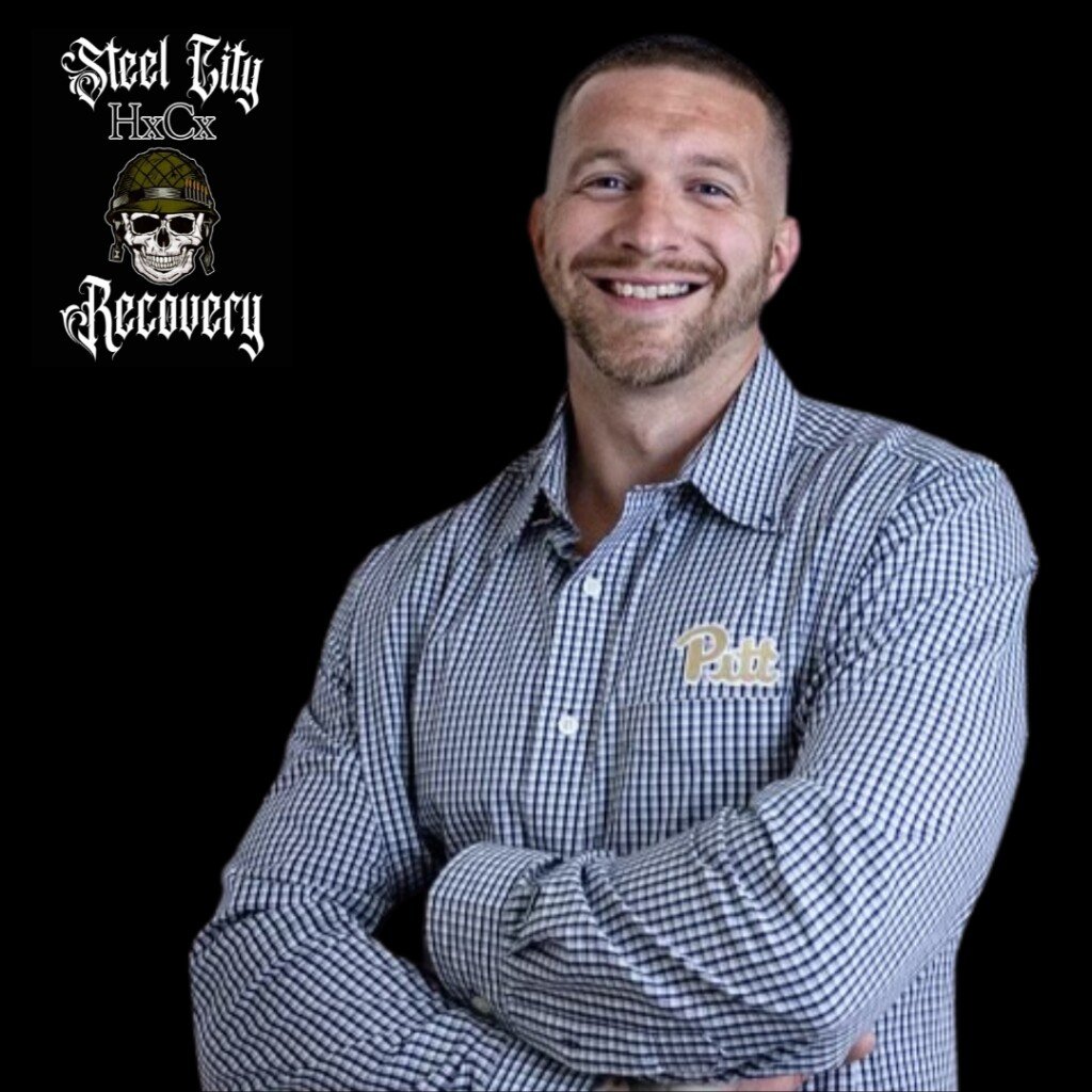 A portrait of Patrick Bibza smiling with his arms crossed, wearing a checkered shirt with the logo of the University of Pittsburgh. The Steel City Hardcore Recovery logo is in the top left corner. The background is black.