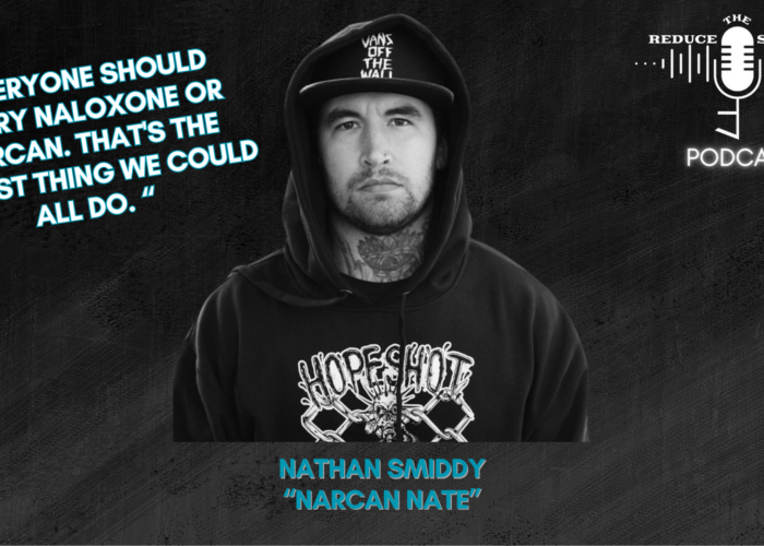 A podcast graphic for "Reduce The Stigma" featuring Nathan Smiddy, also known as "Narcan Nate." The image shows Nate in a black hoodie and a cap, with the quote: "Everyone should carry naloxone or Narcan. That's the easiest thing we could all do." The "Reduce The Stigma Podcast" logo is in the top right corner. Harm Reduction is the focus of the episode